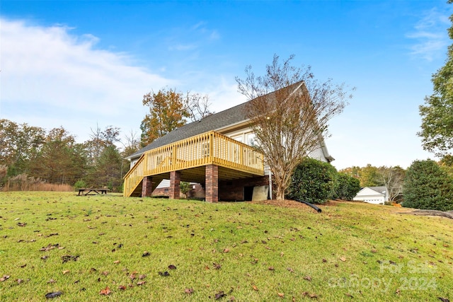 rear view of property with a lawn and a deck