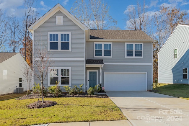 view of property with a front yard and a garage