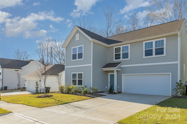 view of front of home featuring a front lawn and a garage