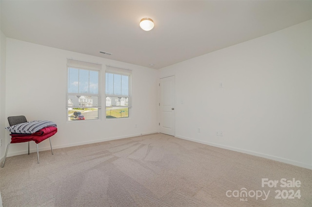 empty room featuring light colored carpet