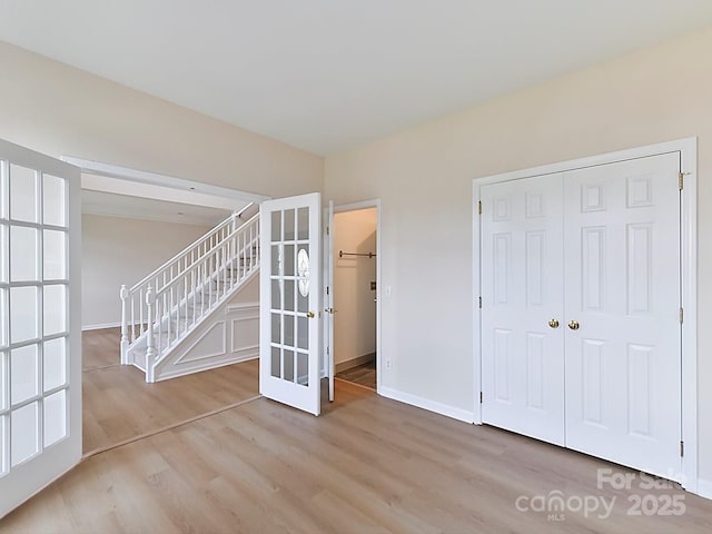 interior space with light hardwood / wood-style flooring and french doors