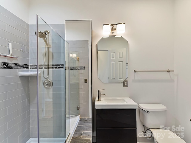 bathroom featuring vanity, toilet, and a shower with shower door