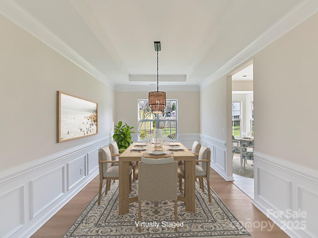 dining space featuring a tray ceiling, dark hardwood / wood-style flooring, and a notable chandelier