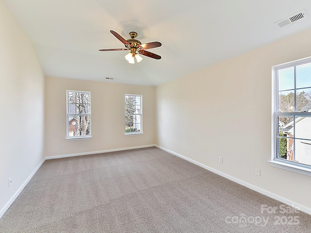 carpeted spare room featuring ceiling fan