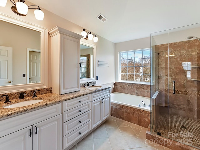 bathroom with tile patterned flooring, vanity, and independent shower and bath