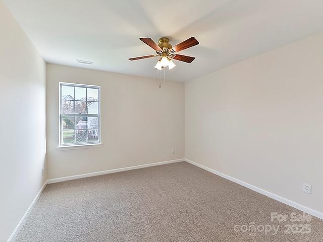 empty room featuring carpet flooring and ceiling fan