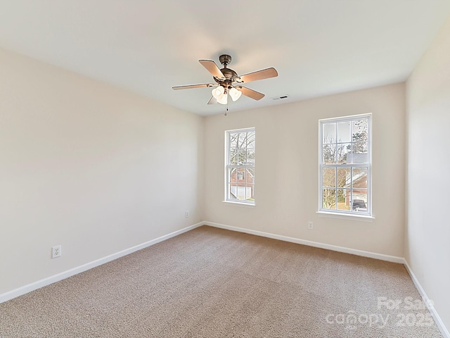 unfurnished room featuring ceiling fan and carpet floors