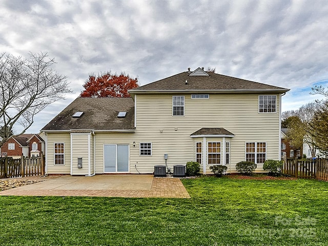 back of house featuring a yard, cooling unit, and a patio