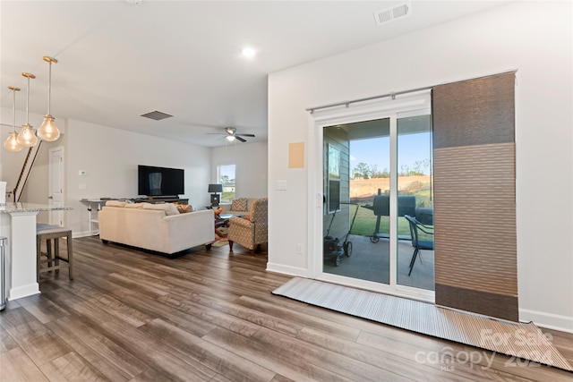 living room with dark hardwood / wood-style floors and ceiling fan