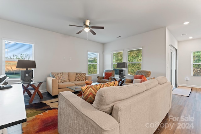 living room with dark hardwood / wood-style floors, plenty of natural light, and ceiling fan