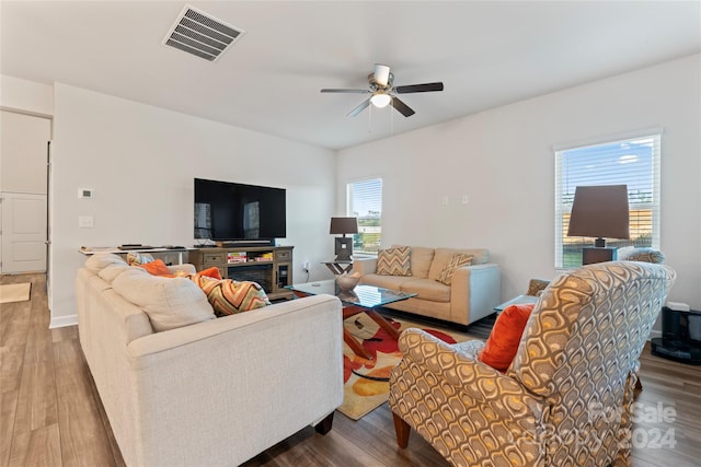 living room with ceiling fan and hardwood / wood-style flooring