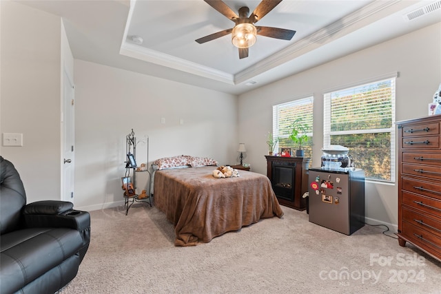 bedroom featuring ceiling fan, stainless steel fridge, a raised ceiling, and light colored carpet