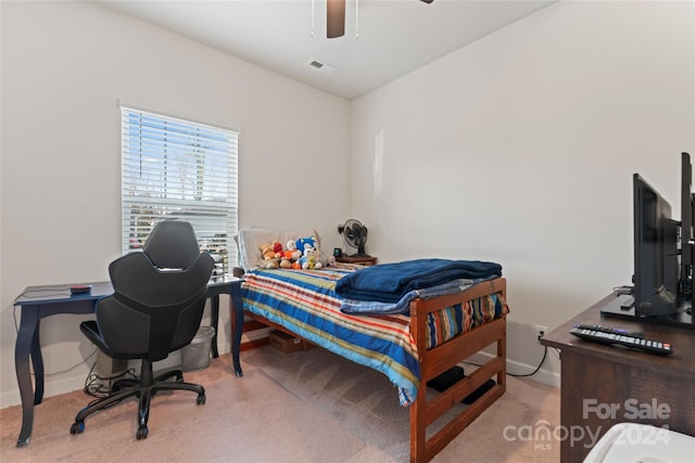 bedroom with ceiling fan and light carpet