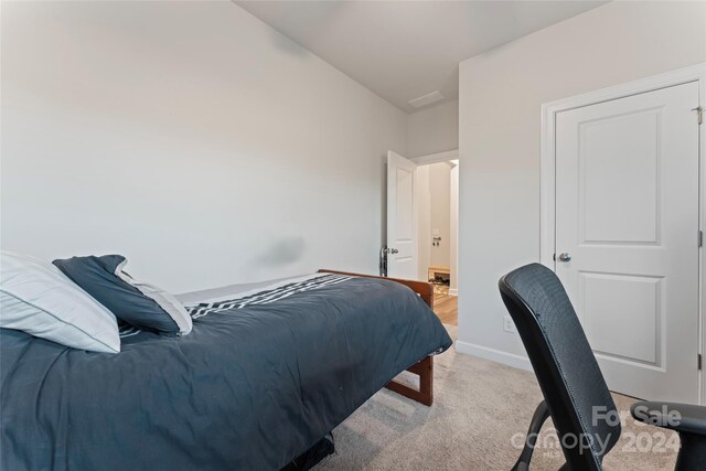 bedroom featuring light colored carpet