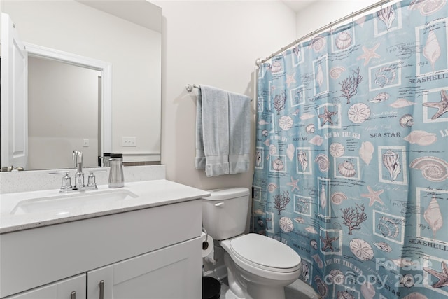 bathroom with a shower with curtain, vanity, and toilet