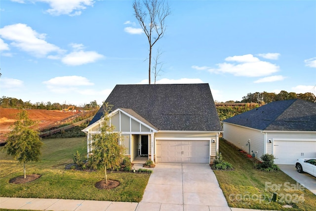 view of front of house with a front yard and a garage