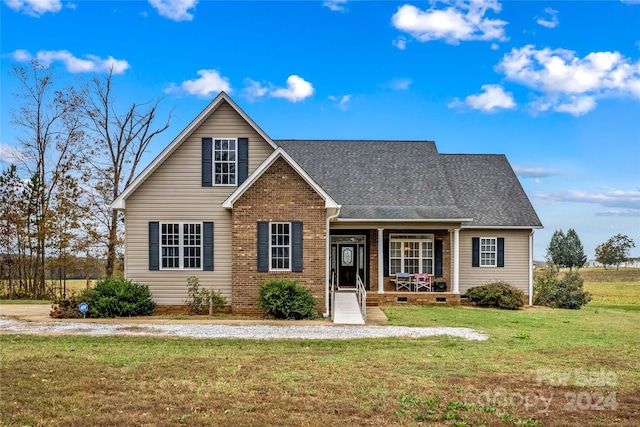 view of front of house with covered porch and a front lawn