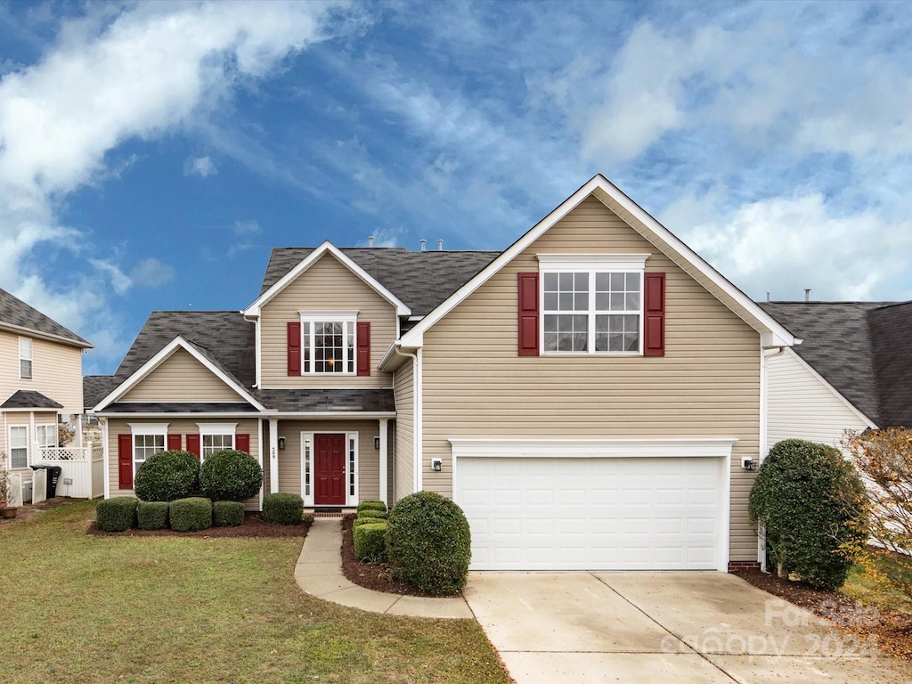 view of front property with a front yard and a garage