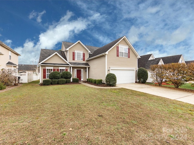 view of front of property featuring a garage and a front lawn