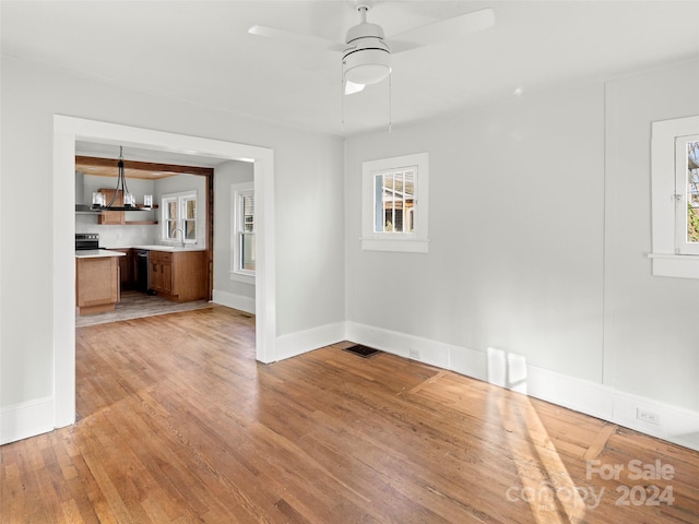 interior space with light hardwood / wood-style floors, sink, and ceiling fan