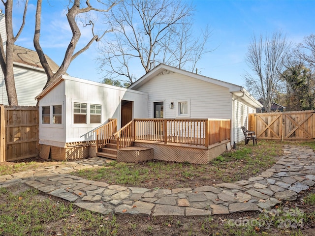 back of property featuring a wooden deck