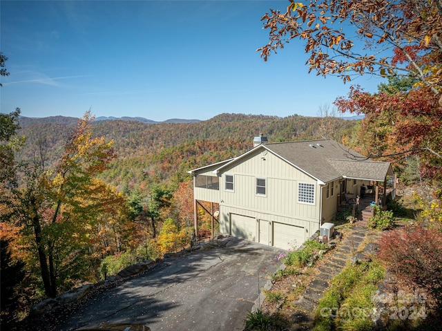 exterior space featuring a garage and a mountain view