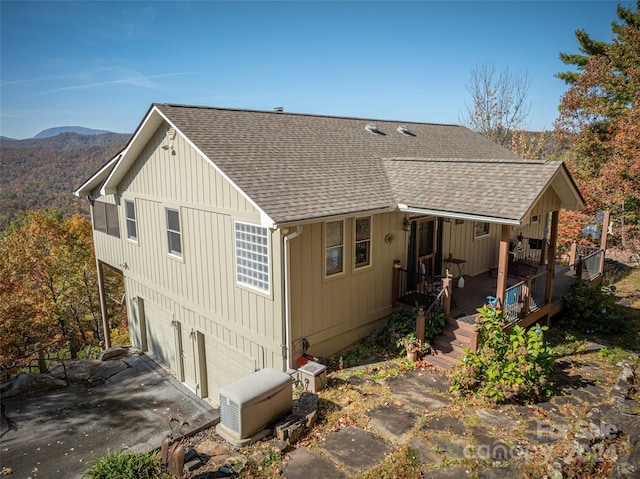 rear view of house featuring a mountain view and a garage