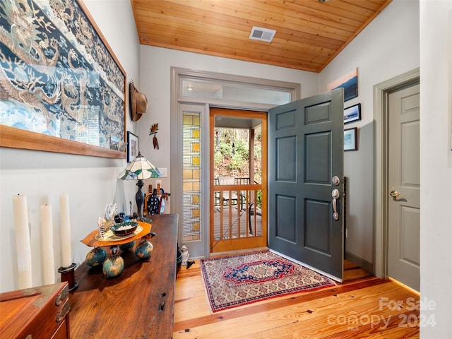 entryway with hardwood / wood-style floors and wooden ceiling