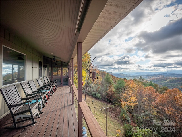 deck featuring a mountain view and ceiling fan