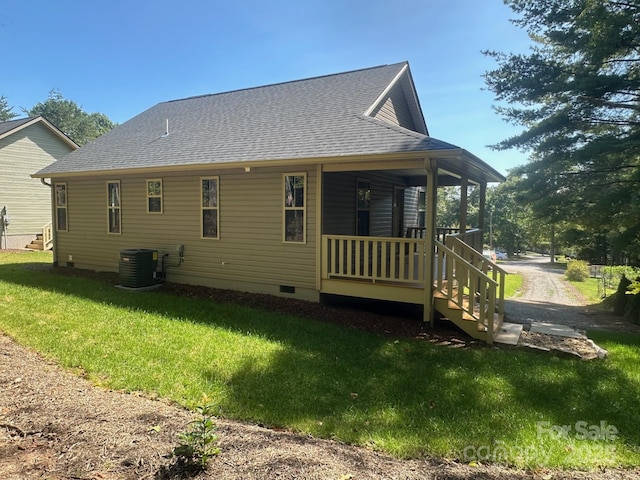 back of house featuring central AC unit, a yard, and a porch