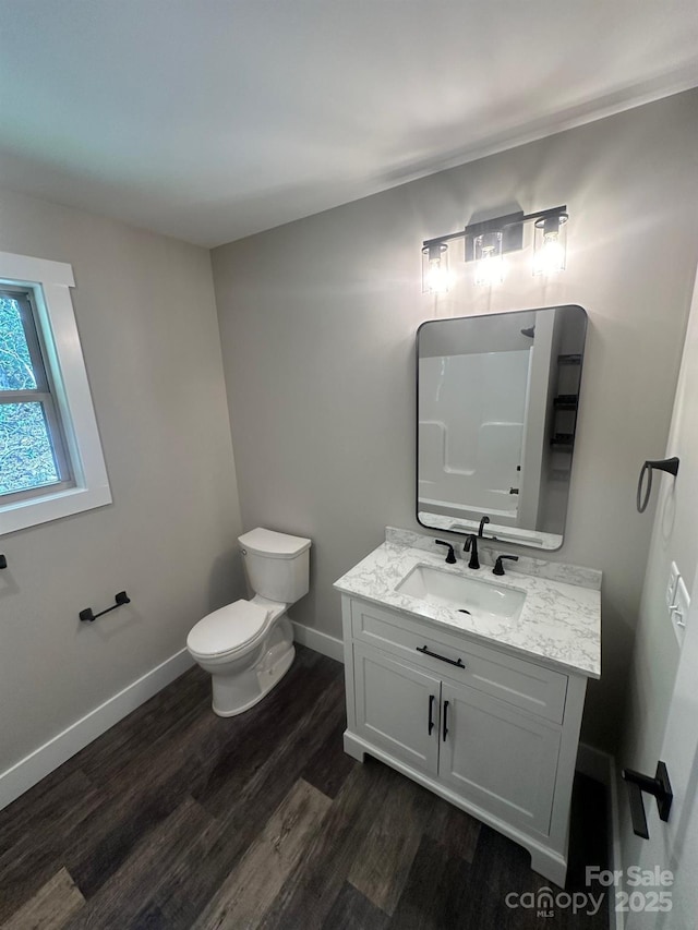 bathroom with vanity, hardwood / wood-style floors, and toilet