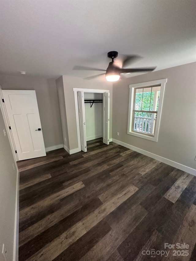 unfurnished bedroom featuring ceiling fan, dark hardwood / wood-style flooring, and a closet