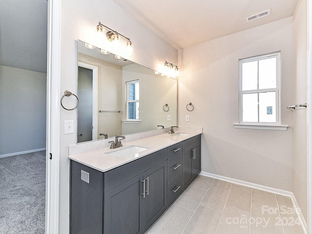 bathroom featuring tile patterned flooring and vanity