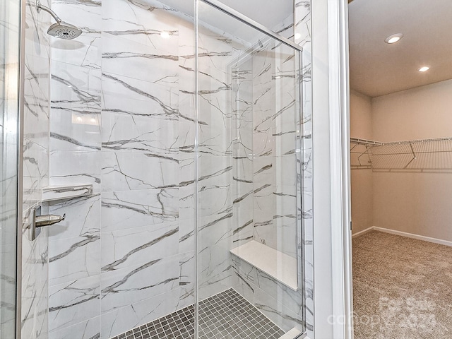 bathroom featuring a shower with shower door