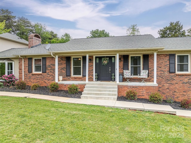 ranch-style home featuring a front yard and a porch