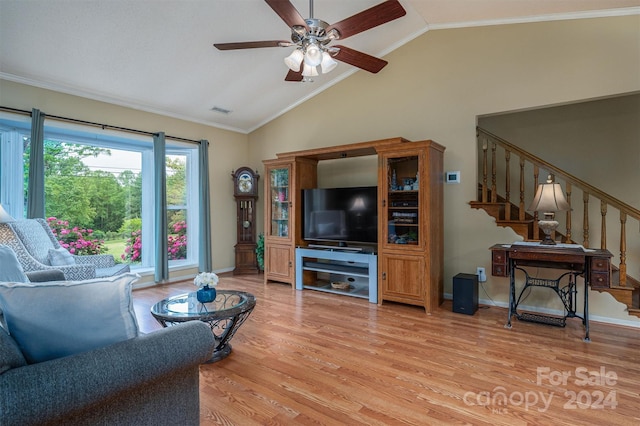 living room featuring ornamental molding, light hardwood / wood-style flooring, lofted ceiling, and ceiling fan