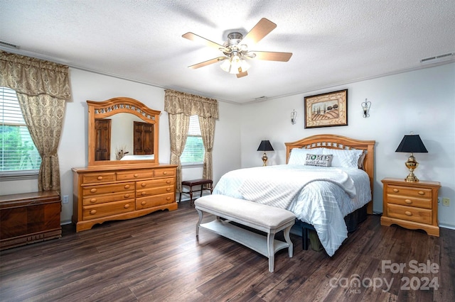 bedroom featuring dark wood-type flooring, multiple windows, and ceiling fan