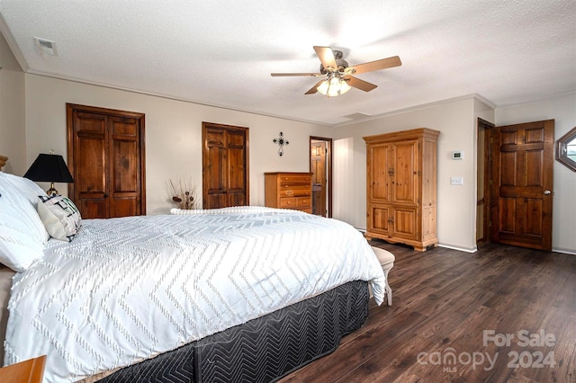 bedroom with dark hardwood / wood-style flooring, ornamental molding, a textured ceiling, and ceiling fan