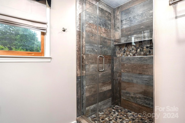 bathroom with a shower with door