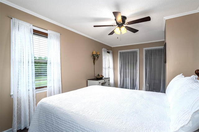 bedroom with a textured ceiling, ceiling fan, and crown molding