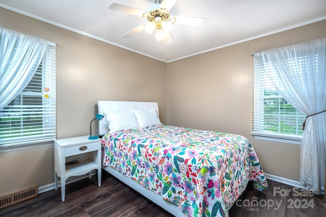 bedroom with dark wood-type flooring, ceiling fan, and crown molding