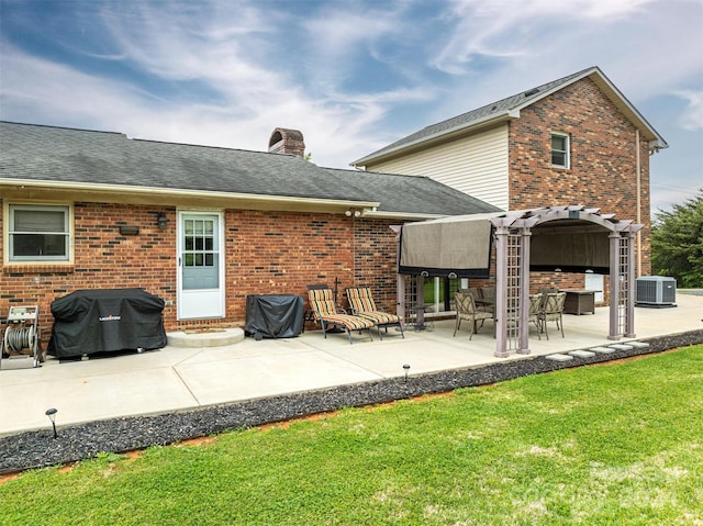 rear view of property featuring central air condition unit, a pergola, a yard, and a patio area