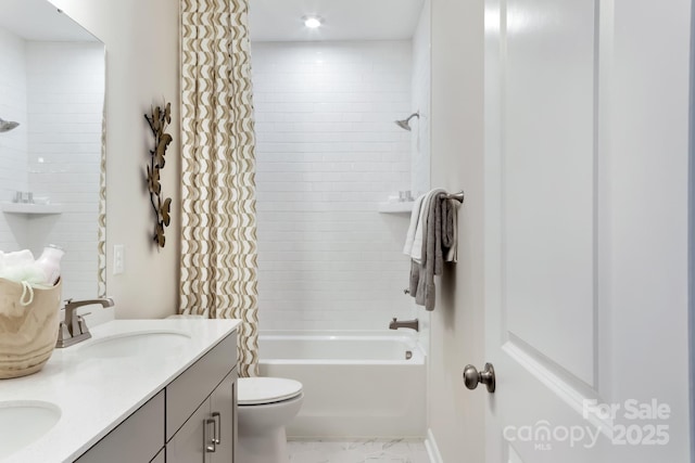 full bathroom featuring vanity, toilet, and tiled shower / bath