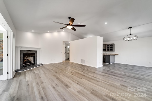 unfurnished living room with vaulted ceiling, light hardwood / wood-style flooring, and ceiling fan