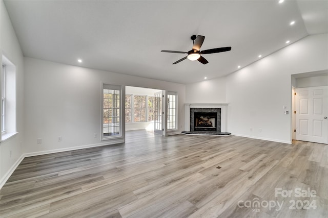 unfurnished living room with light wood-type flooring, vaulted ceiling, and ceiling fan