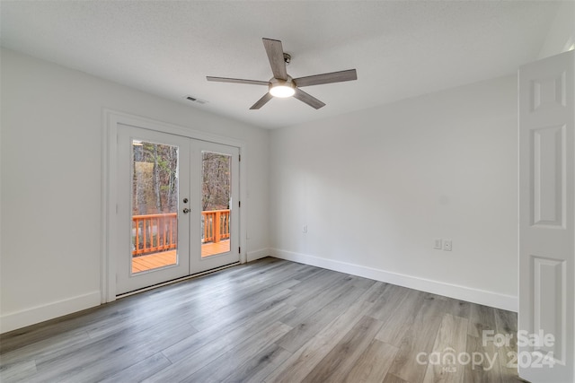 unfurnished room with ceiling fan, french doors, a textured ceiling, and light hardwood / wood-style flooring