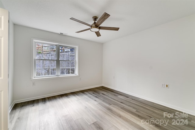 empty room featuring ceiling fan and light wood-type flooring