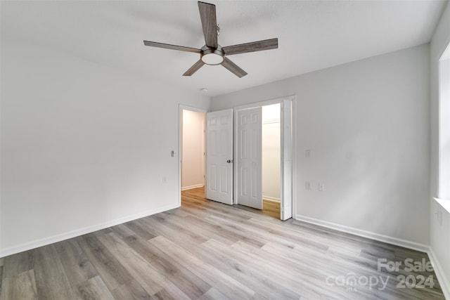 unfurnished bedroom featuring light wood-type flooring and ceiling fan