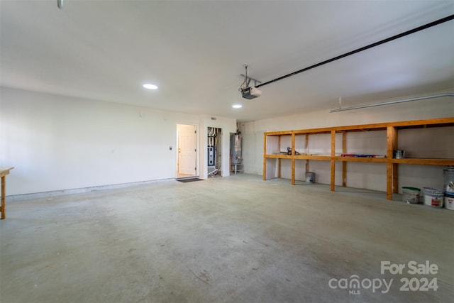 garage featuring water heater and a garage door opener