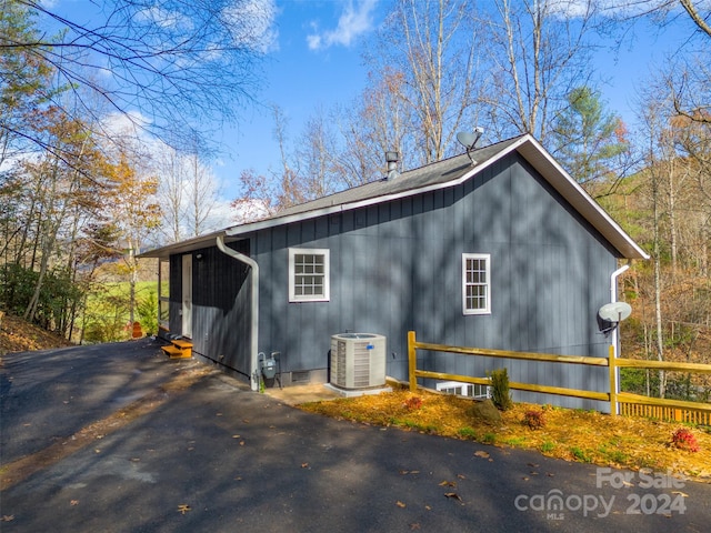 view of side of home featuring cooling unit